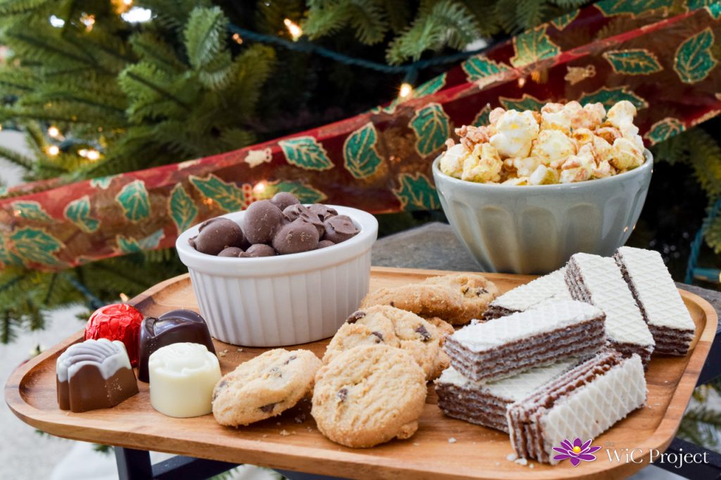 A platter of Chocolate dipped peanuts, cookies, truffles, wafer cookies